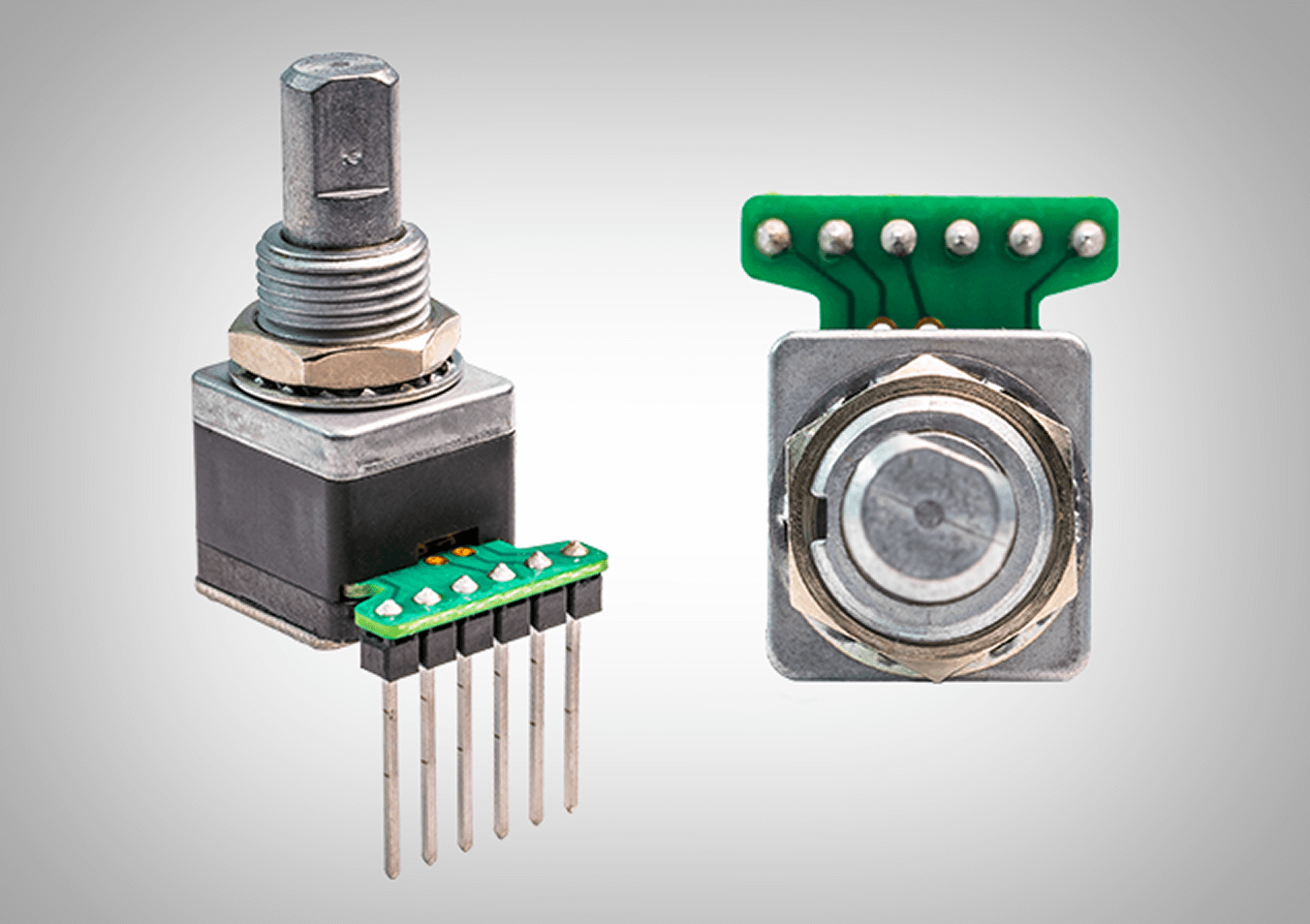 Two views of the Grayhill 62A-D-V Premium Haptic Rotary Encoder, one showing a front-angle view of the shaft and pins, and the other showing a bottom view of the printed circuit board.